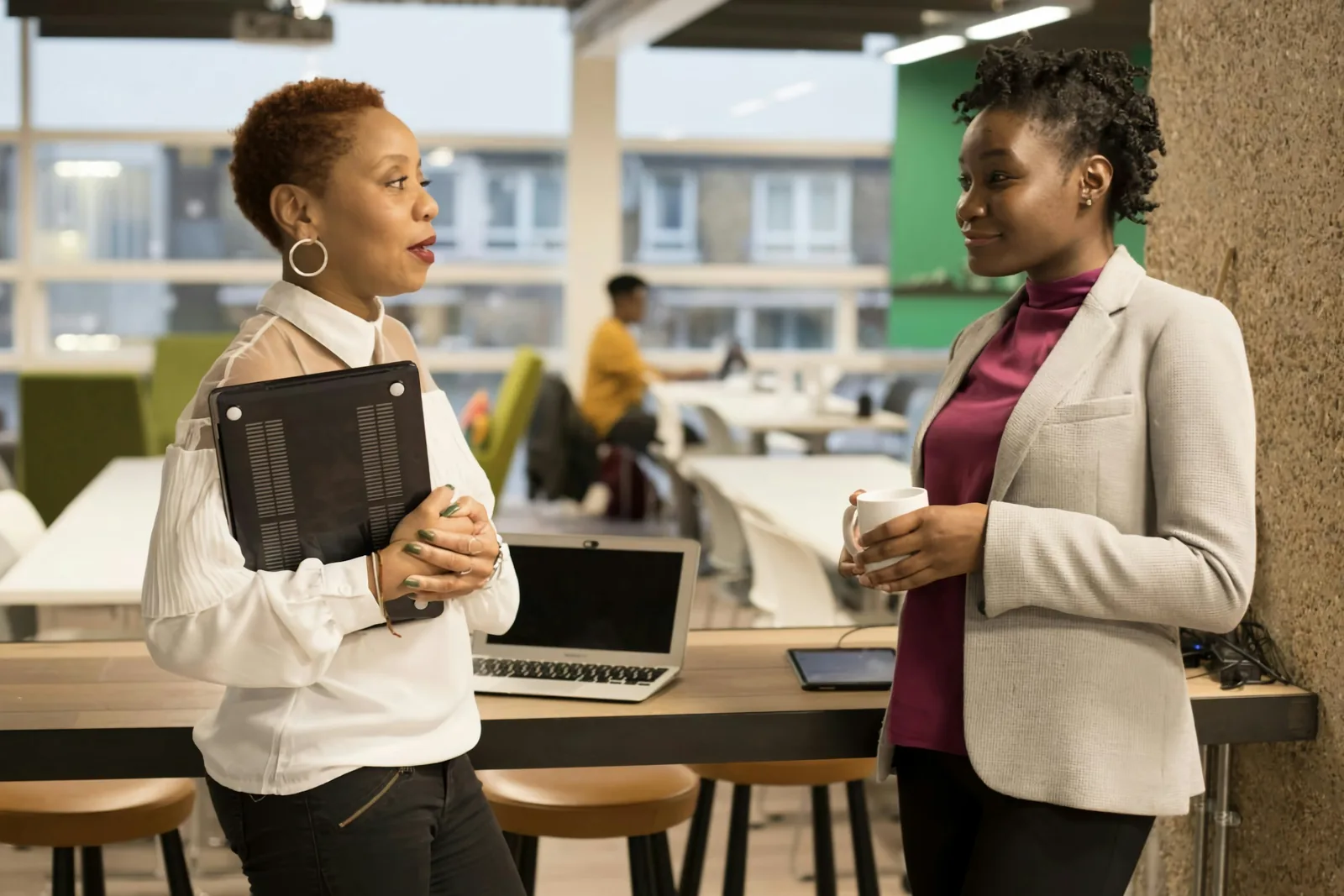 Two colleagues reviewing records together in a bright, modern office